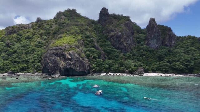 aerial drone view of the lush volcanic landscape and pristine turquoise waters of Castaway Island, a tropical paradise in the Mamanuca Islands of Fiji.