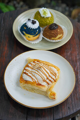 Sweet assorted pastries with colorful cream puffs, soft airy texture, creamy rich filling, and delightful dessert flavor, modern caf&eacute; style presentation with inviting visuals and appetizing charm