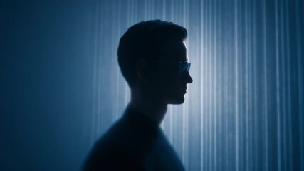 Silhouette man profile glasses cyber futuristic technology blue digital abstract dark shadow anonymous front view sunglasses neon glow streak rain virtual sci fi modern stylish minimal portrait - Powered by Adobe