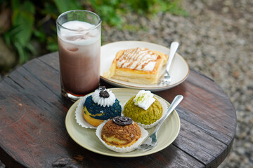 Sweet assorted pastries with colorful cream puffs, soft airy texture, creamy rich filling, and delightful dessert flavor, modern caf&eacute; style presentation with inviting visuals and appetizing charm