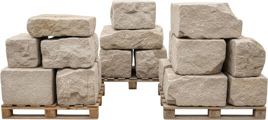 Stacked light beige rough cut stone blocks and rough hewn quarried rock pieces are arranged on wooden pallets ready for construction building material quarry material natural stone