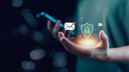 A glowing email icon with a shield, padlock, and password symbol above a hand holding a phone, representing mobile data security, email privacy, password protection, and secure communication.