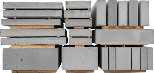 Stacked concrete blocks and beams resting on wooden pallets showing various sizes and textures in a construction material storage yard industrial heavy building infrastructure urban