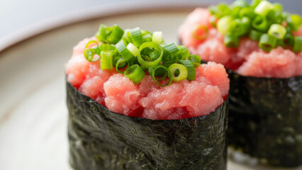 Close-up of fresh negitoro gunkan sushi, made with minced tuna and garnished with chopped scallions, wrapped in nori seaweed.