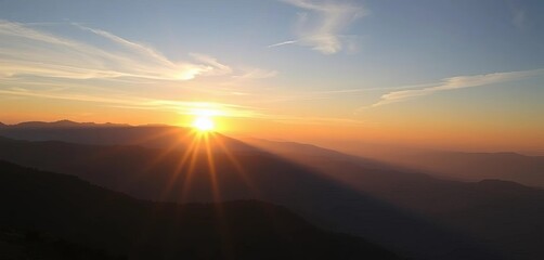 Sunrise over mountain range, symbolizing fresh starts and potential,  hope,  color