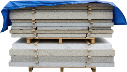 Stacked slabs of granite and marble stone protected by a blue tarp are neatly arranged on wooden pallets ready for construction or industrial use material building industry quarry natural stone