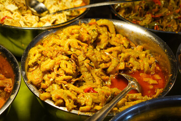 Assorted traditional Indonesian dishes with vibrant homemade flavors, mixed vegetables, fried fish, savory side dishes, and rustic market-style presentation, rich cultural culinary visuals