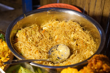 Assorted traditional Indonesian dishes with vibrant homemade flavors, mixed vegetables, fried fish, savory side dishes, and rustic market-style presentation, rich cultural culinary visuals