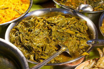 Assorted traditional Indonesian dishes with vibrant homemade flavors, mixed vegetables, fried fish, savory side dishes, and rustic market-style presentation, rich cultural culinary visuals