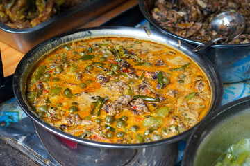 Assorted traditional Indonesian dishes with vibrant homemade flavors, mixed vegetables, fried fish, savory side dishes, and rustic market-style presentation, rich cultural culinary visuals