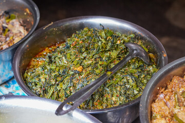 Assorted traditional Indonesian dishes with vibrant homemade flavors, mixed vegetables, fried fish, savory side dishes, and rustic market-style presentation, rich cultural culinary visuals