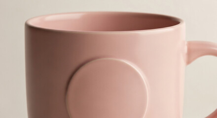 Mockup of a pastel blush pink ceramic mug, tight framing on the front surface, soft minimalist studio background