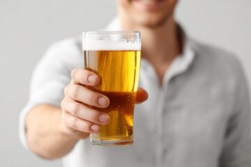 Man drinking beer, relaxed expression, casual lifestyle, refreshing beverage moment, modern leisure concept.