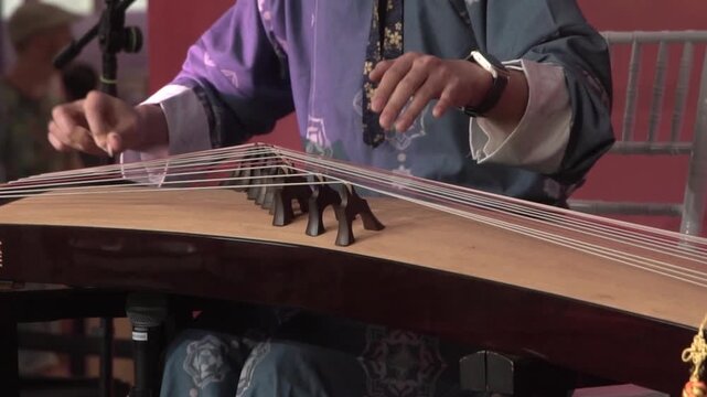 Chinese traditional musician playing Chinese guzheng