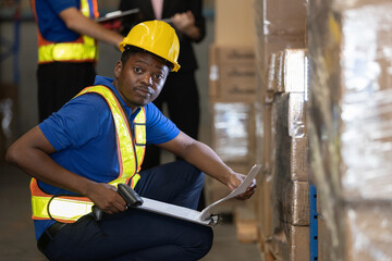 Warehouse worker inspecting inventory with barcode scanner and checklist in storage area, representing logistics, accuracy, and warehouse management in modern supply chain systems.