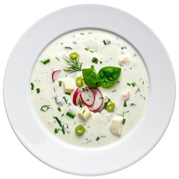 Chilled chalap yogurt drink soup with chopped herbs and cucumbers, presented in a glass and isolated on a white background