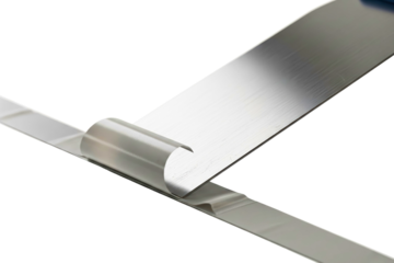 Metal putty knife removing strip of white tape from the surface isolated with transparent background