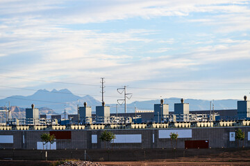 Large data center campus with multiple industrial buildings and utility infrastructure, representing cloud computing facilities, digital storage operations, and large scale information technology deve