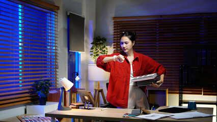 female Interior Designer working late at night in her dimly lit studio