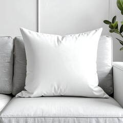 Close-up of a white pillow on a gray couch, modern interior decor