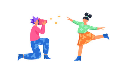 A professional photographer kneeling while taking a picture of a young girl posing and dancing with joy against a white background