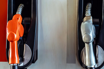 Petrol fuel nozzle for fuelling in petrol fuel station. Hand refilling car with fuel at gas...