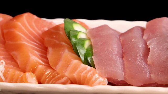 Close-up of Fresh Sashimi Platter Rotating on Black Background