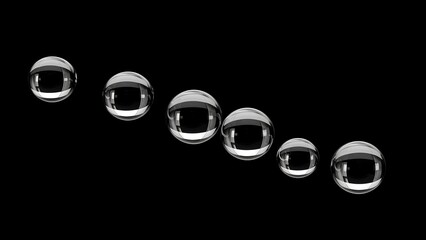 A close-up macro photograph captures a series of transparent water droplets arranged in a descending diagonal line against a stark black background.