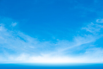 A bright, clear blue sky meets a glowing white horizon, suggesting a serene, open, and with sunlight of beautiful cloudy sky. landscape or abstract background.	
