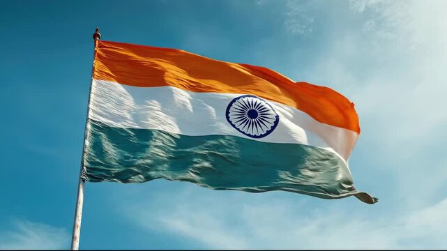 National flag of India waving in the wind against a clear blue sky, Indian Tricolor or Tiranga symbol of patriotism