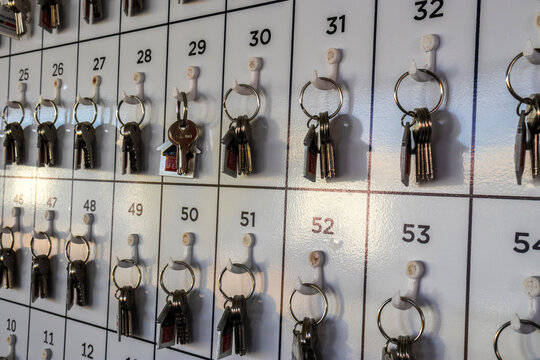 Marilia, SP, Brazil. June 27, 2025. Keys organized on a numbered rack. One key with a house-shaped fob stands out, representing concepts like new home, real estate, finding the right solution