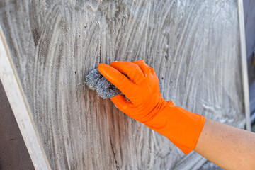 Hand Cleaning Window Screen with Steel Wool at Home