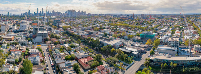 Aerial panorama view of a widespread suburban city with a distant skyline