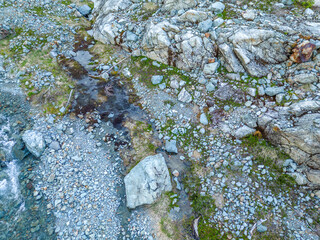 Rugged Rocky Slope With Large Boulders and Small Stream in British Columbia Wilderness
