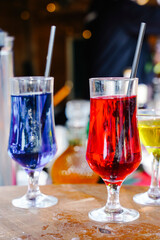Assorted Colorful Fruit Cocktails with Straws and Garnish on a Bar Counter