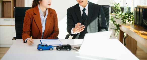 Asian couple consulting personal finance and household budget with financial advisor. Car loan...