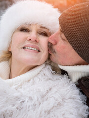 Lovers Exchanging Affection In Cold Weather, Couple Displaying Warmth And Love During Chilly Winter Day, Man And Woman Sharing Tender Kiss On Cheek Amidst Relaxed Winter Atmosphere