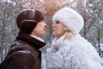Playful Snowy Clash, Couple In Winter Woodland Fun, Two Individuals Engaging In Playful Winter Forest Confrontation, Duo Sharing Lively Interactions Amidst Snow Covered Trees And Chilly Air