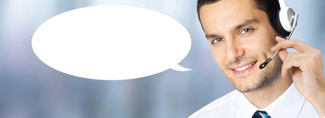 Call center. Businessman business man callcenter support phone operator in microphone headset on blurred office background with white empty mockup speech bubble. Customer service help. Free text space