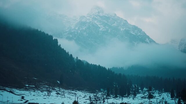 4k Winter mountain landscape with clouds andlight snow. Bad weather during winter day, view after fresh snowfall at Aru Valley, Jammu and Kashmir, India. Travel and holidays concept.