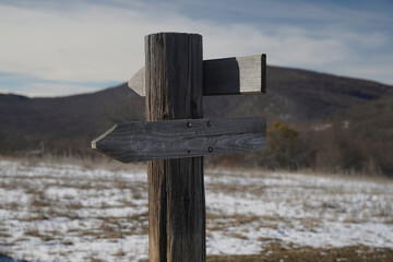 Blank Wooden Directional Signpost in Winter Mountain Landscape