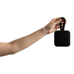 A hand holding a small black square bag with a handle isolated on transparent background