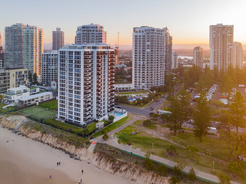 Aerial view of highrise apartment buildings in a coastal city at sunset