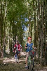 Naklejka premium Happy Asian Boys Aiming Slingshots in Rural Countryside.