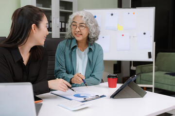 Fototapeta premium Asian businessman discuss with new startup project Idea presentation, analyze planning and financial statistics and investment market at office.