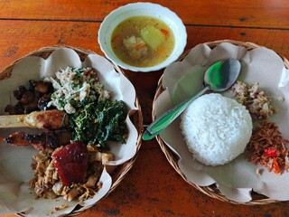 Traditional meal served on wooden table with rice and soup