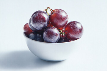 Bowl of Grapes: A cluster of plump, juicy grapes sits invitingly in a pristine white bowl.  Perfect for promoting health, wellbeing, and natural goodness.