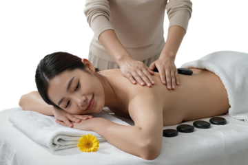 Woman receiving hot stone massage from therapist