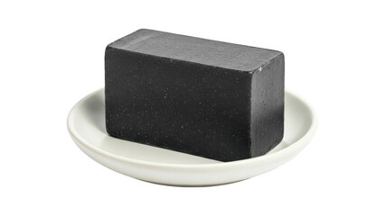 Black soap bar on a white plate isolated on transparent background