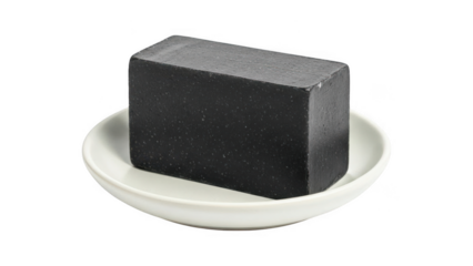 Black soap bar on a white plate isolated on transparent background